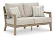 Hallow Creek Outdoor Loveseat with Cushion - Atchison Furniture Company (Atchison, KS)