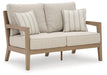 Hallow Creek Outdoor Loveseat with Cushion - Atchison Furniture Company (Atchison, KS)